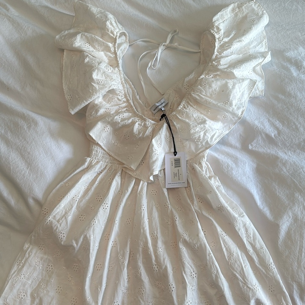 White eyelet V-Neck ruffle mini, smocked waist by “WeWoreWhat”. New w/tags